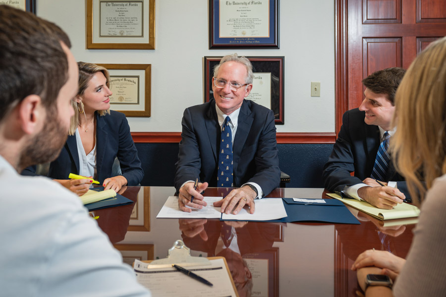 Attorney Timothy M. Ingram, Sr. smiling as he meets with clients & the other attorneys at Ingram Injury Law